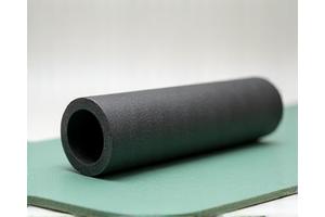A compact foam roller on a yoga mat.