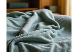 Soft, textured weighted blanket draped over a sofa.